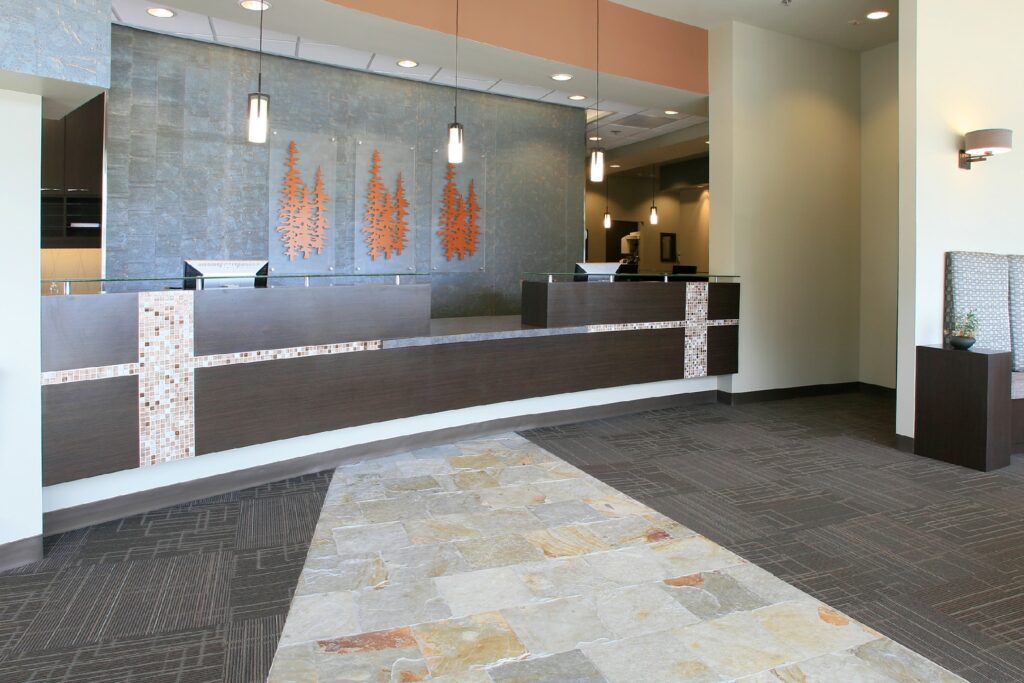 Modern dental office reception area with front desk, contemporary lighting, and welcoming lobby space.