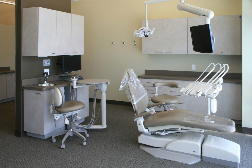Modern dental operatory with chair, equipment, and cabinetry in professional clinical setting.