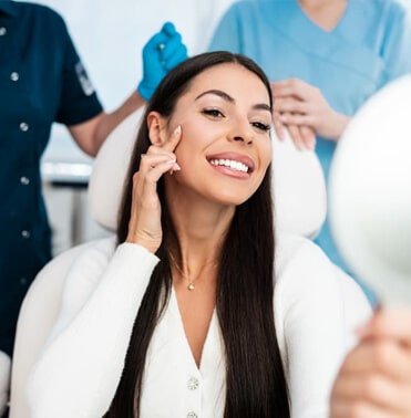 Woman receiving dental examination from hygienist in professional dental office setting.